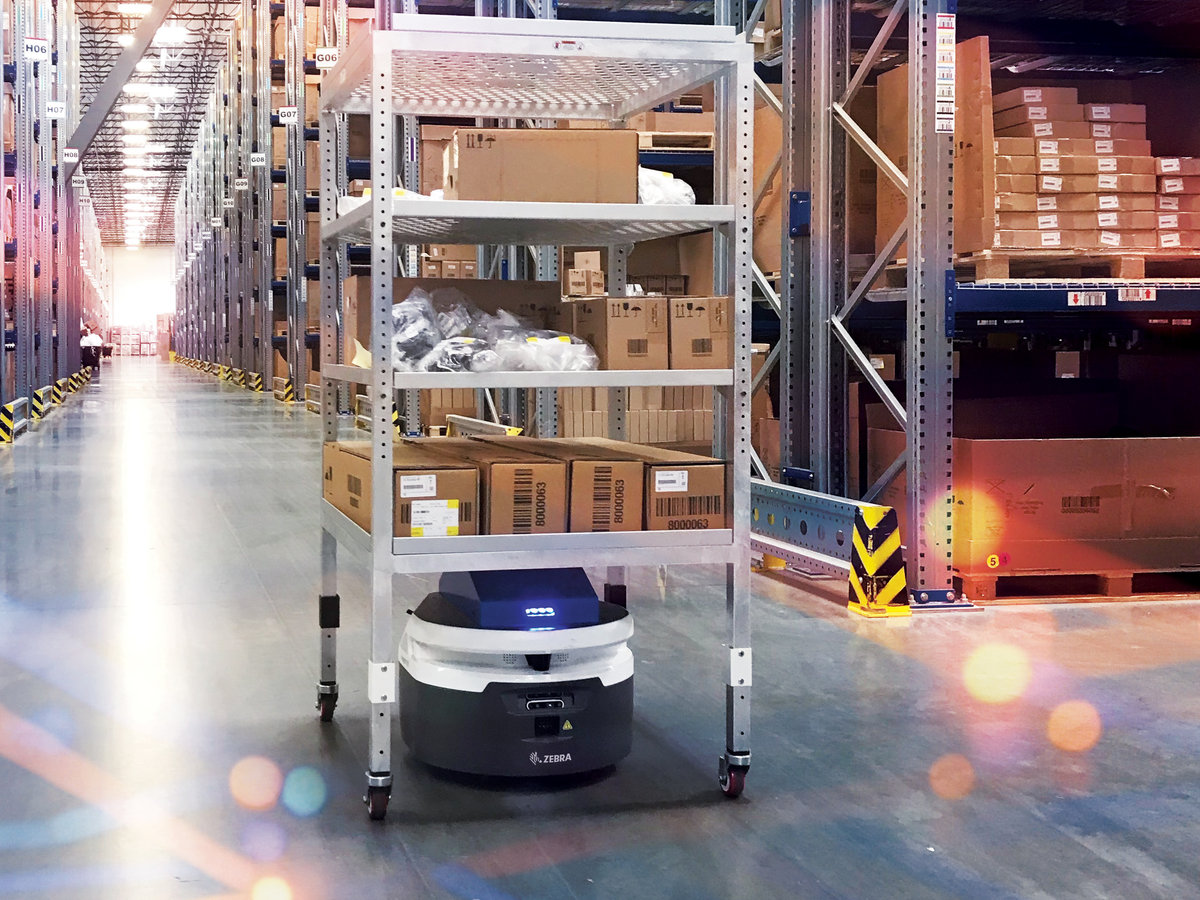 Autonomous mobile robot towing a rack of inventory bins